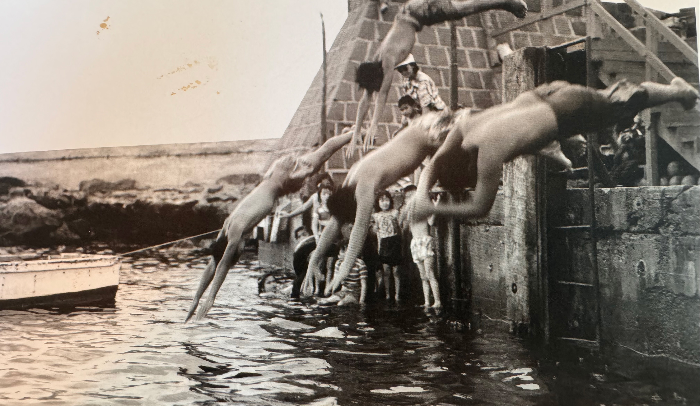 Black and white photos of a historic dive, possibly showcasing divers in action.