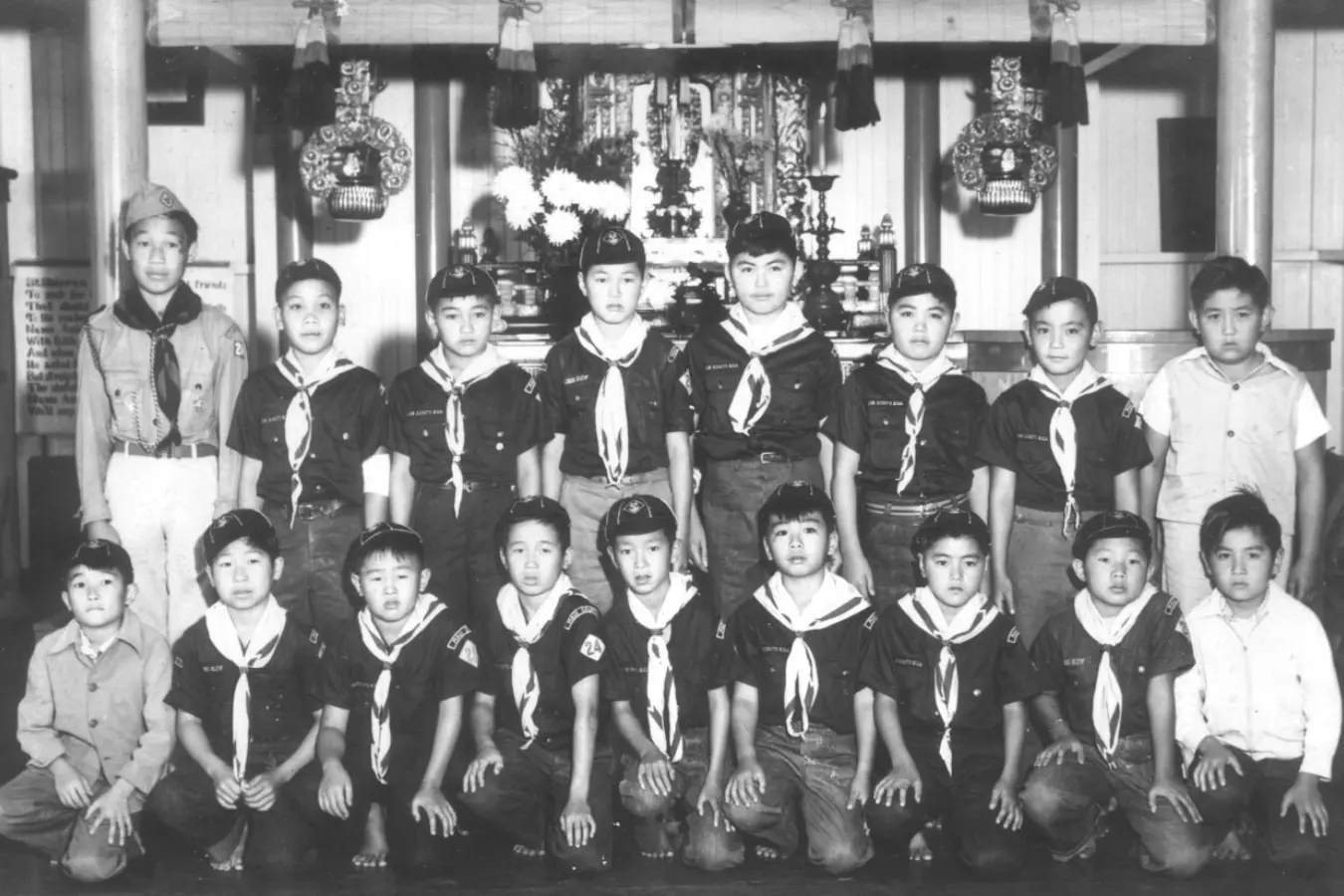 Black and white photo of Boy Scouts in uniform, posing together for a team picture. The Scouts stand side by side, displaying pride and unity in their uniforms, capturing a moment of teamwork and dedication.