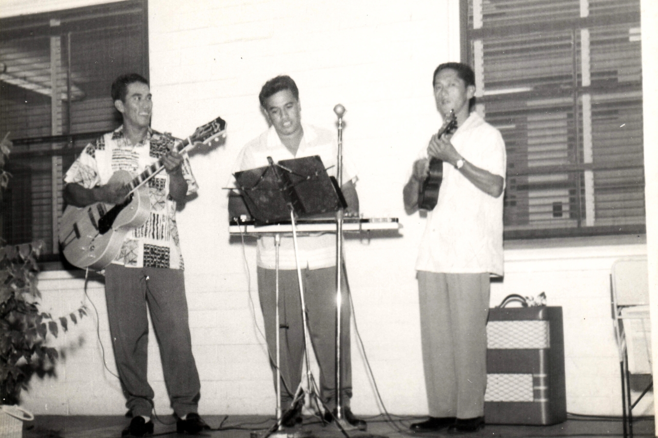 Three men playing musical instruments together on a cozy porch, creating a lively and joyful atmosphere.