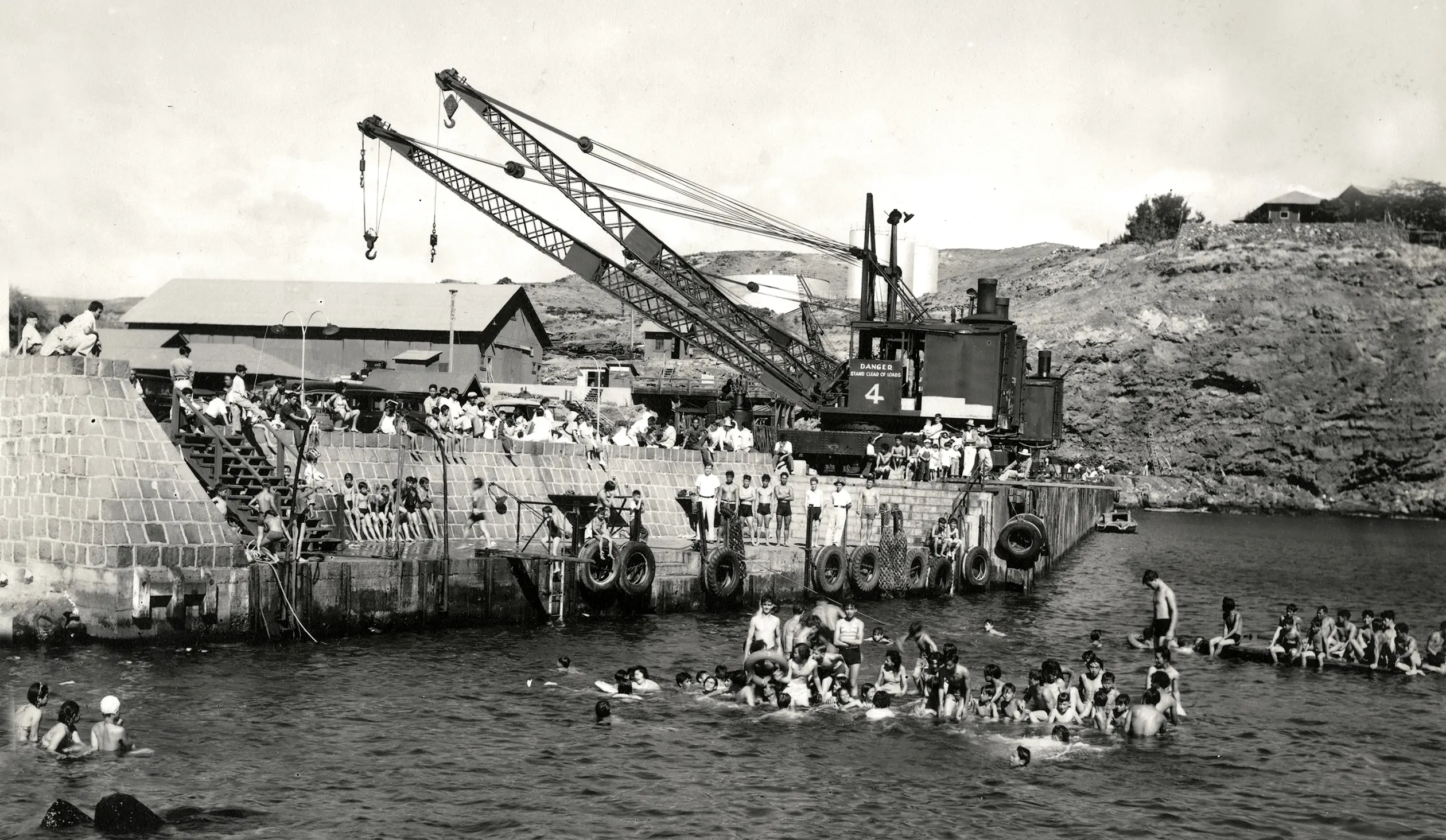A black and white photo capturing people enjoying themselves in the water.