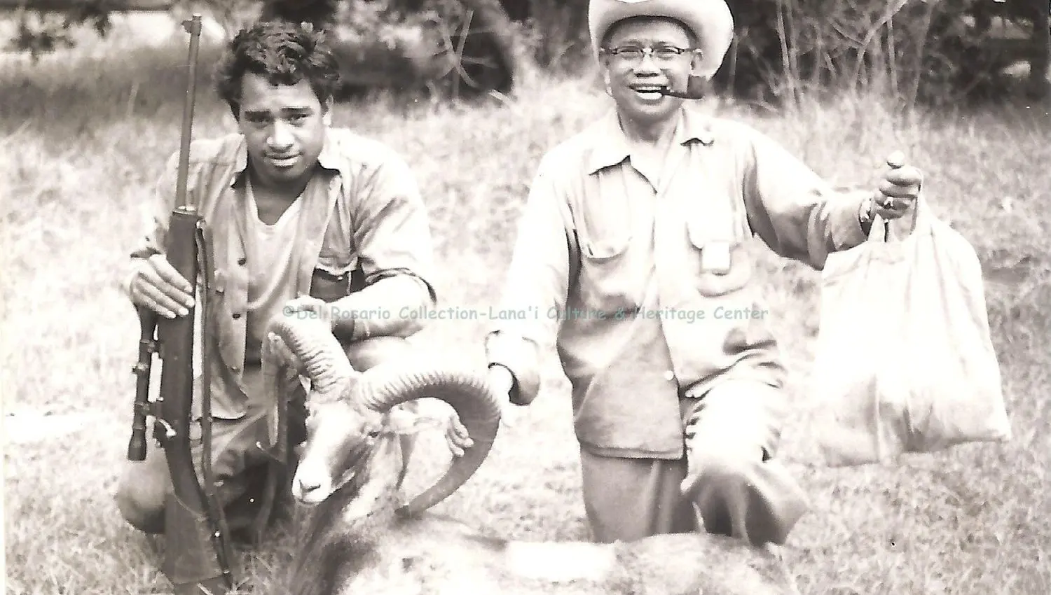 two men holding the head of a ram